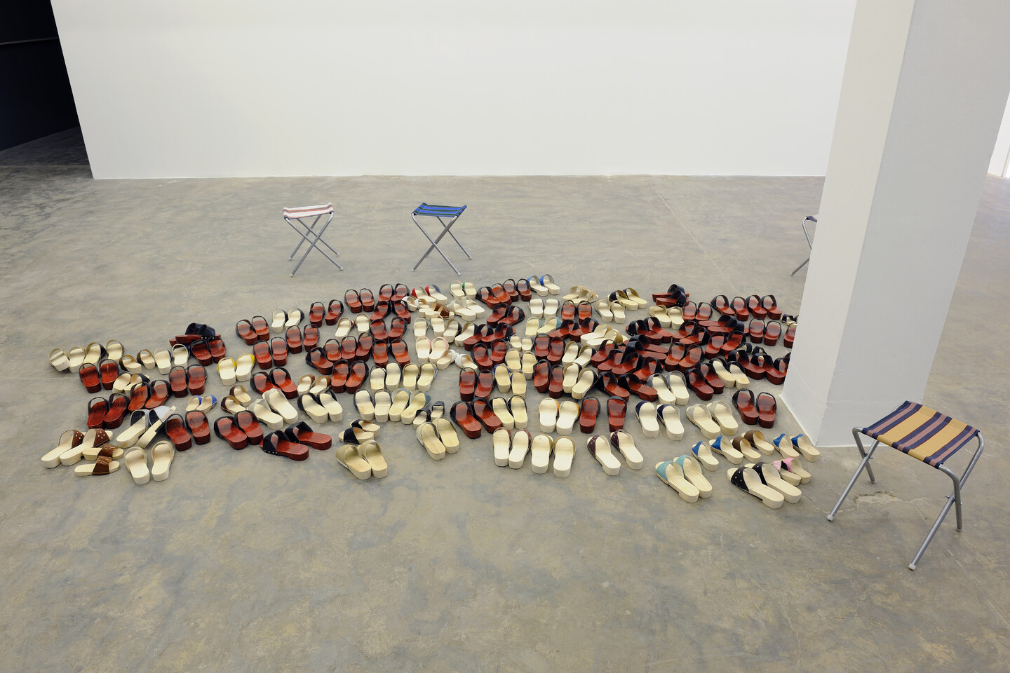 Clogged, 2014, Installation with 100 pairs of wooden clogs dispursed across the floor, dimensions variable