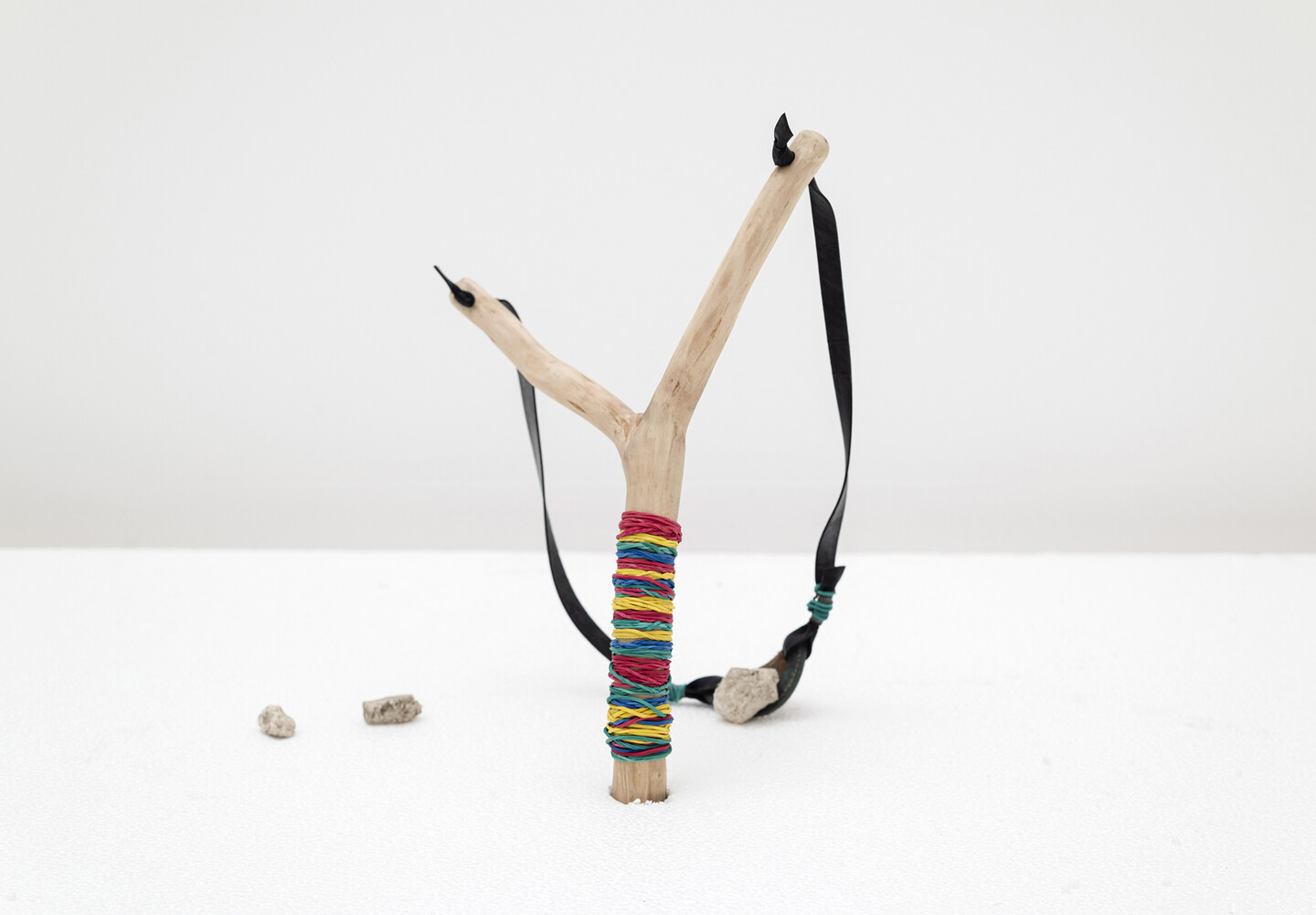 Slingshot, 2024, Wood, rubber, stones, leather, 35 &times; 65 cm